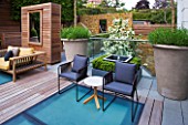 MODERN ROOF GARDEN BY STEPHEN WOODHAMS, LONDON: TERRACE/SEATING AREA WITH WOODEN BENCH, CHAIRS, LAVENDER IN LARGE CONTAINERS, DECKING WITH FROSTED GLASS SKYLIGHTS, SCREEN, MIRROR, DECKS, DECKING, DECKED