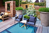 MODERN ROOF GARDEN BY STEPHEN WOODHAMS, LONDON: TERRACE/SEATING AREA WITH WOODEN BENCH, CHAIRS, LAVENDER IN LARGE CONTAINERS, DECKING WITH FROSTED GLASS SKYLIGHTS, SCREEN, MIRROR, DECKS, DECKING, DECKED