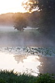 NARBOROUGH HALL  NORFOLK: DAWN LIGHT ON MIST ON THE RIVER NAR