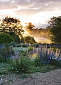 NARBOROUGH HALL  NORFOLK: DAWN LIGHT ON THE RIVER NAR AND THE GRAVEL GARDEN IN FRONT OF THE HALL