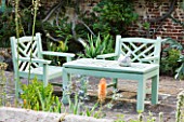 SANDHILL FARM HOUSE  HAMPSHIRE - DESIGNER ROSEMARY ALEXANDER - GREEN PAINTED WOODEN BENCH AND CHAIRS ON PATIO