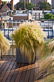 LONDON ROOFTOP GARDEN: WOODEN DECKING AND METAL CONTAINER PLANTED WITH STIPA TENUISSIMA