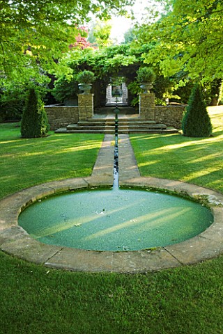 DESIGNER_ALISON_HENRY__PRIVATE_GARDEN_COTSWOLDS_LAWN_AND_RILL_TO_FORMAL_ROUND_POND__POOL__LAWN_STONE