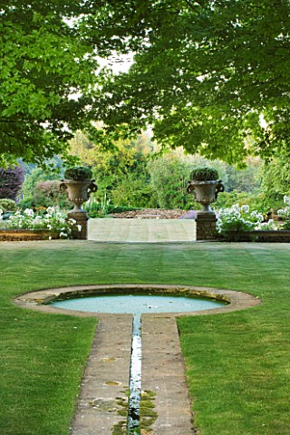 DESIGNER_ALISON_HENRY__PRIVATE_GARDEN_COTSWOLDS_LAWN_AND_RILL_TO_FORMAL_ROUND_POND__POOL__LAWN_STONE