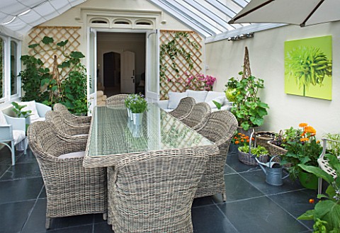 DESIGNER_CLARE_MATTHEWS_CONSERVATORY_WITH_WICKER_TABLE_AND_CHAIRS