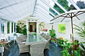 DESIGNER CLARE MATTHEWS: CONSERVATORY WITH WICKER TABLE AND CHAIRS