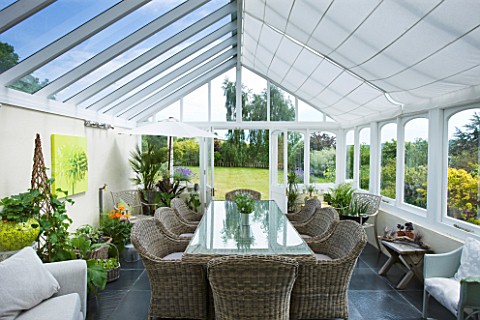 DESIGNER_CLARE_MATTHEWS__CONSERVATORY_WITH_WICKER_TABLE_AND_CHAIRS
