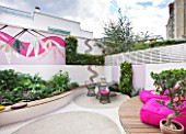 SMALL TOWN GARDEN  LONDON. DESIGNER - ANA SANCHEZ - MARTIN  OF GERMINATE DESIGN. PINK AND WHITE GARDEN WITH DECKING  PINK CHAIRS  MOSAIC BY CELIA GREGORY