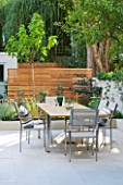 @JARDINROSAINSPIRATIONS - SMALL TOWN GARDEN: VIEW FROM KITCHEN TO WHITE PORCELAIN TILED DINING AREA/ PATIO.TABLE AND CHAIRS - A PLACE TO SIT