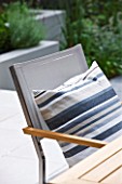 @JARDINROSAINSPIRATIONS - SMALL TOWN GARDEN: CHAIR BESIDE A TABLE WITH STRIPED CUSHION