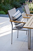@JARDINROSAINSPIRATIONS - SMALL TOWN GARDEN: WHITE PORCELAIN TILED DINING AREA/ PATIO. TABLE WITH CHAIR AND STRIPED CUSHION