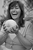 DESIGNER CLARE MATTHEWS: BLACK AND WHITE IMAGE OF CLARE HOLDING  A  SWEETHEART MELON