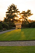 WHATLEY MANOR  WILTSHIRE: VIEW OUT TO THE WILTSHIRE COUNTRYSIDE FROM THE GRAND LAWN  EVENING LIGHT