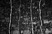 DIGNE LES BAINS  FRANCE: BLACK AND WHITE IMAGE OF WHITE LINES ON BLACK ROCK BY ANDY GOLDSWORTHY