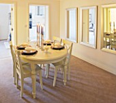 MODERN DINING ROOM WITH MIRRORS ON WALL  CANDLES