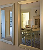 DINING TABLE WITH CANDLES REFLECTED IN MIRROR