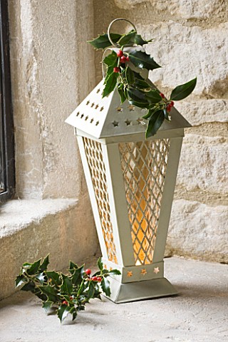 DESIGNER__JACKY_HOBBS__CHRISTMAS_DECORATION__CANDLES_IN_LANTERN_WITH_HOLLY_BERRIES_AND_LEAVES__IN_WI
