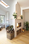 DESIGNER: JACKY HOBBS  LONDON: LIVING ROOM AT CHRISTMAS - TWO SIDED FIREPLACE WITH WOOD BASKET