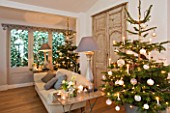 DESIGNER: JACKY HOBBS  LONDON: LIVING ROOM AT CHRISTMAS - SOFA  FAUX FRENCH DOORS  CHRISTMAS TREE