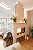 DESIGNER: JACKY HOBBS  LONDON: LIVING ROOM AT CHRISTMAS - DOUBLE SIDED FIREPLACE