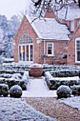 FORMAL TOWN GARDEN IN SNOW  OXFORD  WINTER: DESIGN BY LIZ NICHOLSON - BOX HEDGING WITH HOUSE BEHIND