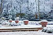 FORMAL TOWN GARDEN IN SNOW  OXFORD  WINTER: DESIGN BY LIZ NICHOLSON - TERRACE WITH ITALIAN TERRACOTTA CONTAINERS PLANTED WITH LAVANDULA AUGUSTIFOLIA HIDCOTE