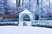 FORMAL TOWN GARDEN IN SNOW  OXFORD  WINTER: DESIGN BY LIZ NICHOLSON - ARBOUR/ GAZEBO  BOX HEGDING AND HORNBEAMS - CARPINUS BETULUS