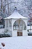 FORMAL TOWN GARDEN IN SNOW  OXFORD  WINTER: DESIGN BY LIZ NICHOLSON - ARBOUR/ GAZEBO  BOX HEGDING  AND HORNBEAMS - CARPINUS BETULUS