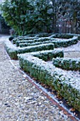 FORMAL TOWN GARDEN IN SNOW  OXFORD  WINTER: DESIGN BY LIZ NICHOLSON - BOX HEDGING IN THE SHAPE OF A LEAF BESIDE THE MAIN DRIVE