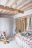 DESIGNER CAROLYN MINTY  GLOUCESTERSHIRE: BEDROOM WITH ROCKING HORSE AND BED - CHRISTMAS