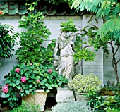 STATUE SUROUNDED BY WISTERIA  HYDRANGEA AMI PASQUIER  LAVENDER LANATA AND VARIEGATED HEBE. OSLER RD  OXFORD