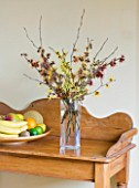 HAMAMELIS ANNE  COOMBE WOOD  JAPONICA VAR MEGALOPHYLLA  ANGELLY  APHRODITE  GINGERBREAD  GLOWING EMBERS  RUBIN  FOXY LADY  MAGIC FIRE  IN GLASS VASE ON SIDEBOARD