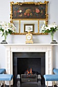 DESIGNER JANE CHURCHILL : THE DRAWING ROOM - MODERN FIREPLACE WITH ANTIQUE FRENCH CLOCK  ANTIQUE SHOP MIRROR AND GLASS VASES FROM JANE CHURCHILLS GRANDMOTHER