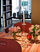 DESIGNER JANE CHURCHILL : THE DINING ROOM WITH LIBRARY BEYOND - YELLOW LINEN WALLS  CUSTOMISED CHAIRS WITH WEBBING AND STUDS ADDED  GLASSES BY IKEA AND WILLIAM YEOWARD
