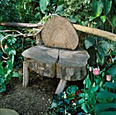 WOODEN SEAT IN THE GARDEN OF THE BARBICAN CONSERVATORY  LONDON