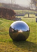 DESIGNER - CLARE MATTHEWS: SILVER BALL SCULPTURE IN GRASS