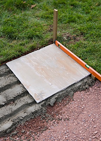 PAVING_PROJECT__DEVON__DESIGNER_CLARE_MATTHEWS__A_BED_OF_MORTAR_WITH_STONE_SLAB_IN_THE_CORNER_AND_SP