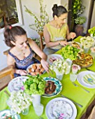 DESIGNER: KALLY ELLIS  LONDON: KALLY ELLIS AND DAUGHTER SOPHIA EATING LUNCH AT THE KITCHEN TABLE