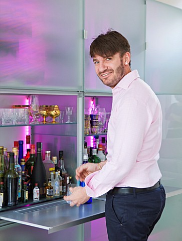 CAKE_BOY_HOUSE__LONDON_ERIC_LANLARD_MAKING_DRINKS_ON_THE_SLIDE_OUT_PANEL_OF_THE_LED_LIT_FROSTED_GLAS