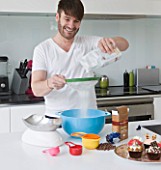 CAKE BOY HOUSE  LONDON: ERIC LANLARD  CAKE BOY  PREPARING A CAKE MIX IN HIS KITCHEN