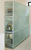 CAKE BOY HOUSE  LONDON: FROSTED GLASS STORAGE CABINET WITH LED COLOUR CHANGER AND SLIDE OUT PANEL FOR DRINKS  BY EO  IN THE LIVING ROOM