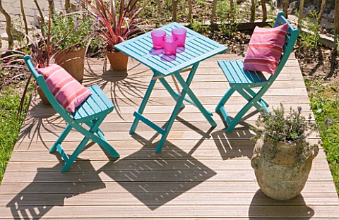 DESIGNER_CLARE_MATTHEWS__DECKING_PROJECT__DECK_FOR_DINING_WITH_BLUE_WOODEN_TABLE_AND_CHAIRS