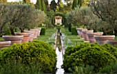 LES CONFINES  PROVENCE  FRANCE - DESIGNER: DOMINIQUE LAFOURCADE - THE MAIN VISTA FROM THE LILY POND DOWN A RILL SURROUNDED BY TERRACOTTA CONTAINERS PLANTED WITH OLIVE TREES