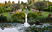 LES CONFINES  PROVENCE  FRANCE - DESIGNER: DOMINIQUE LAFOURCADE - THE MAIN VISTA FROM THE LILY POND DOWN A RILL SURROUNDED BY TERRACOTTA CONTAINERS PLANTED WITH OLIVE TREES