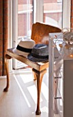 THE BALCONY GARDENER - ISABELLE PALMER - BEDROOM - WOODEN CHAIR WITH HATS BY WINDOW