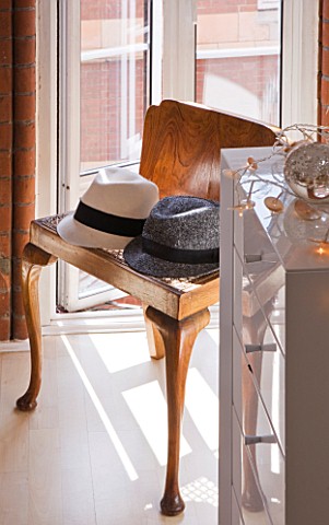 THE_BALCONY_GARDENER__ISABELLE_PALMER__BEDROOM__WOODEN_CHAIR_WITH_HATS_BY_WINDOW