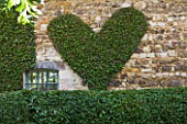 PRIEURE NOTRE-DAME DORSAN  FRANCE: CLIPPED HEART ON WALL