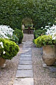 DESIGNER MICHEL SEMINI  PROVENCE  FRANCE: MAS THEO - THE SWIMMING POOL GARDEN WITH PATH THROUGH GRAVEL AND TERRACOTTA CONTAINERS TO COURTYARD BEYOND