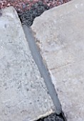 DESIGNER: CLARE MATTHEWS  DEVON - PAVING PROJECT - MORTAR IN CRACK BETWEEN PAVING SLABS AFTER BEING SMOOTHED DOWN WITH A  POINTING IRON
