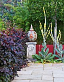 BARBARA KENNINGTON GARDEN  BRIGHTON: MOSAIC SHERE WITH TURKISH TULIP MOTIF SET ON STONE PLINTH SURROUNDED BY VERBASCUMS BY THE POOL